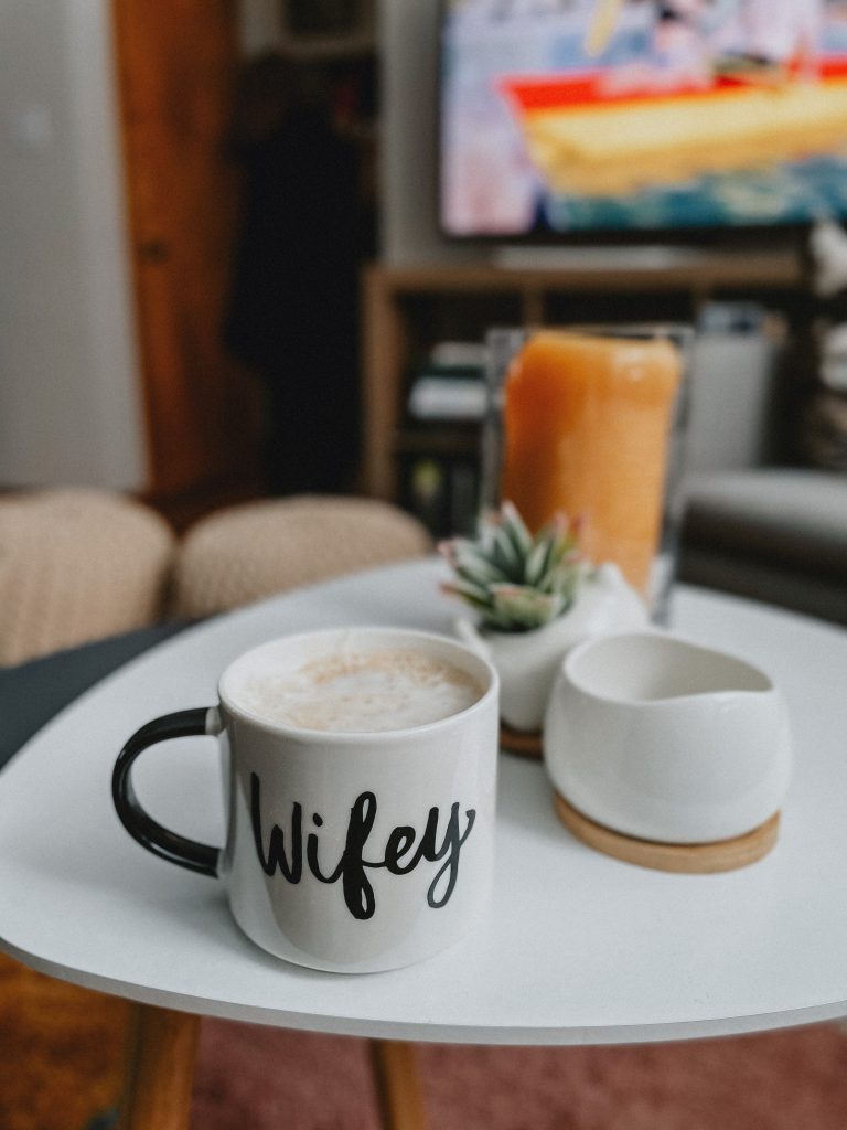 White and black coffee cup with the word,  'wifey", showing a chai tea latte