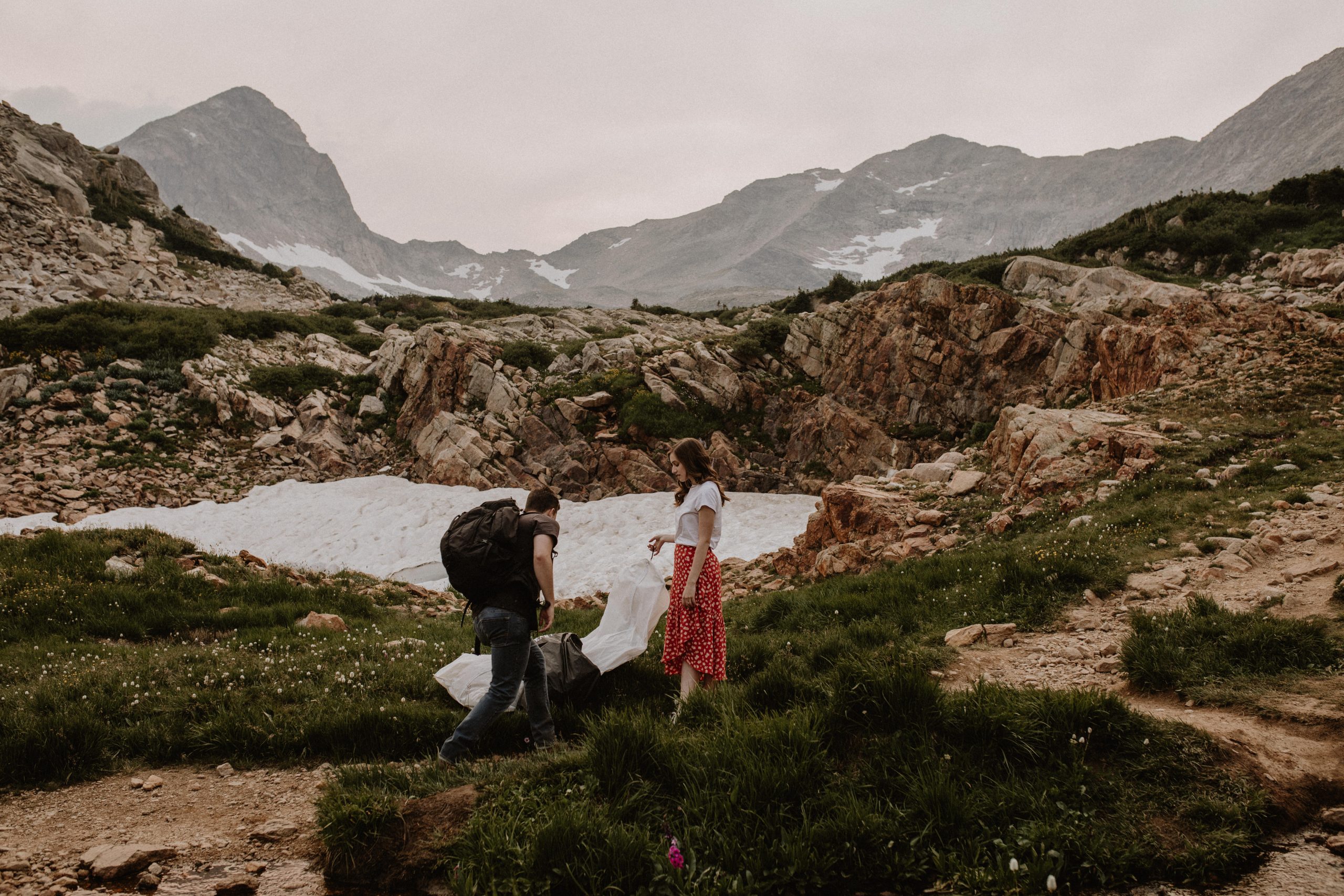 couple getting ready at the top of a mountain trail in Colorado