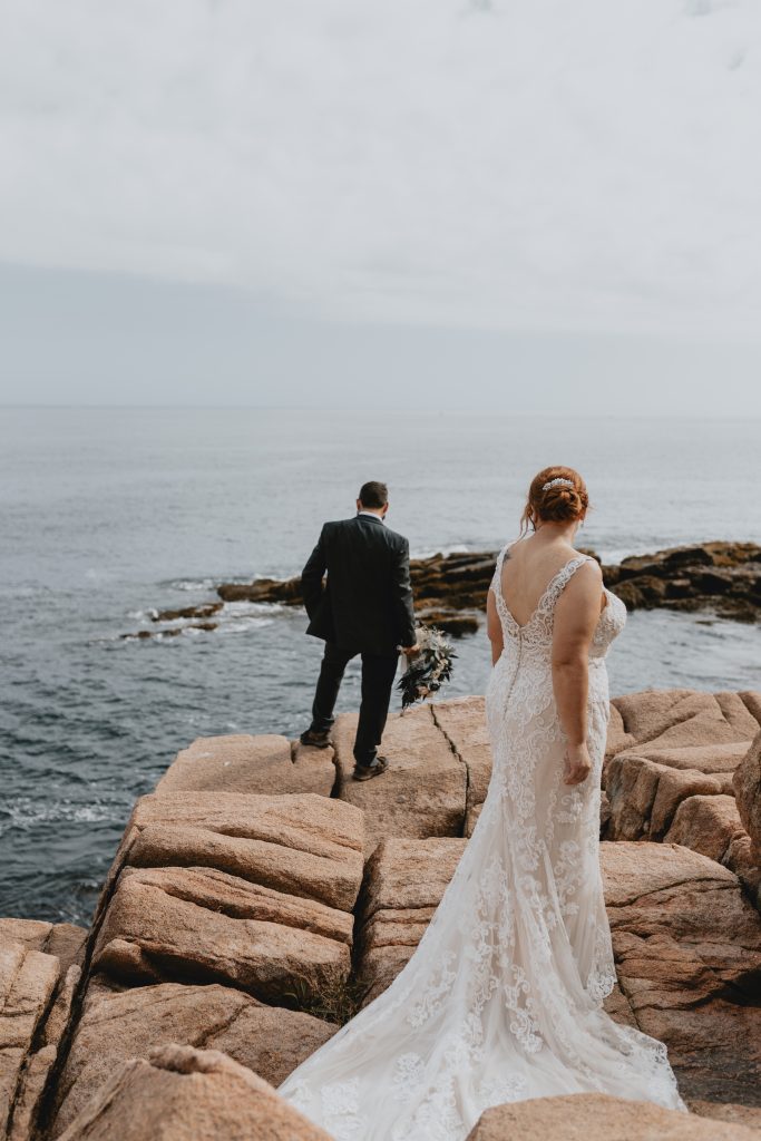 Couple posing in Acadia National Park in wedding attire