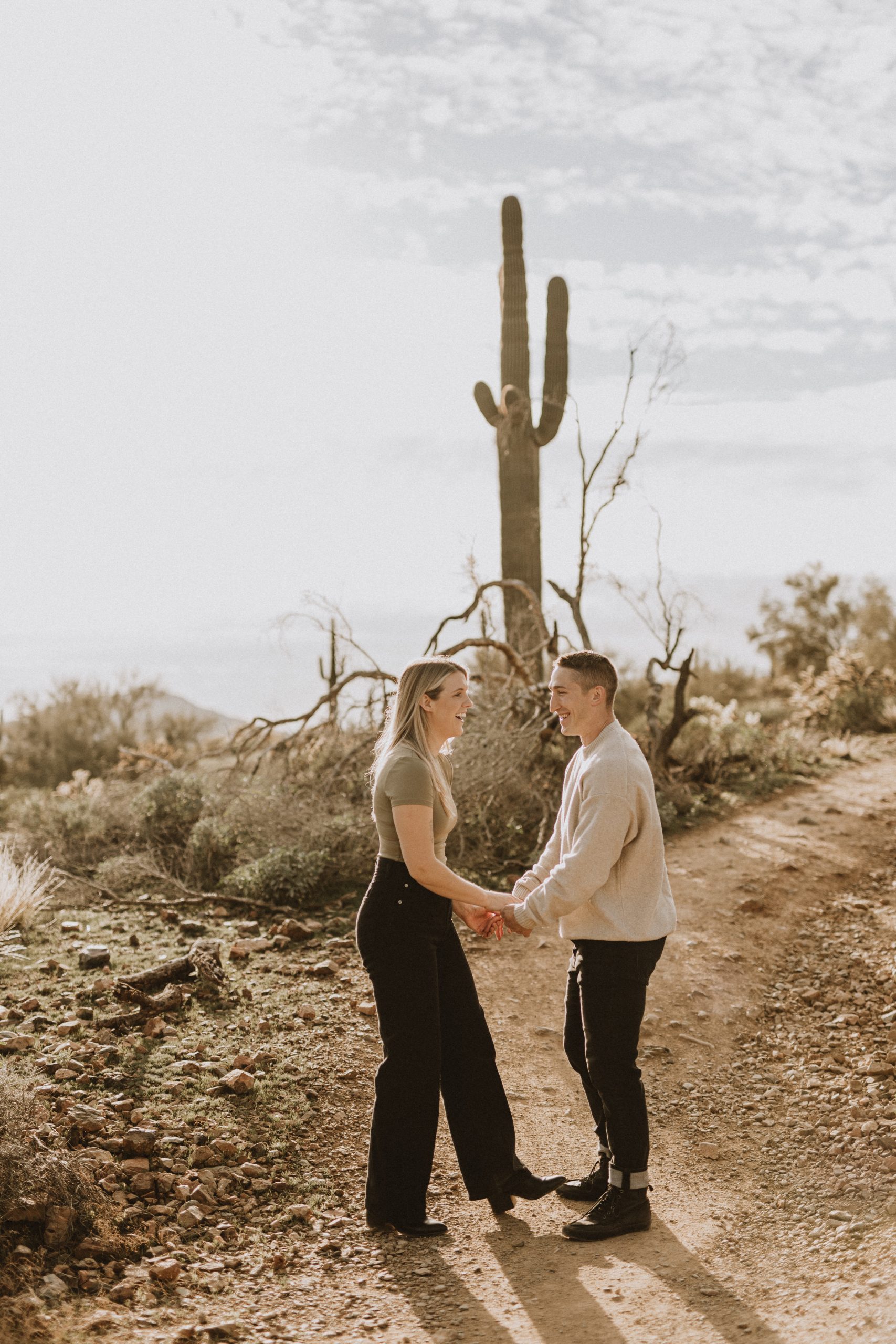 couple walking hand in hand in the arizona desert