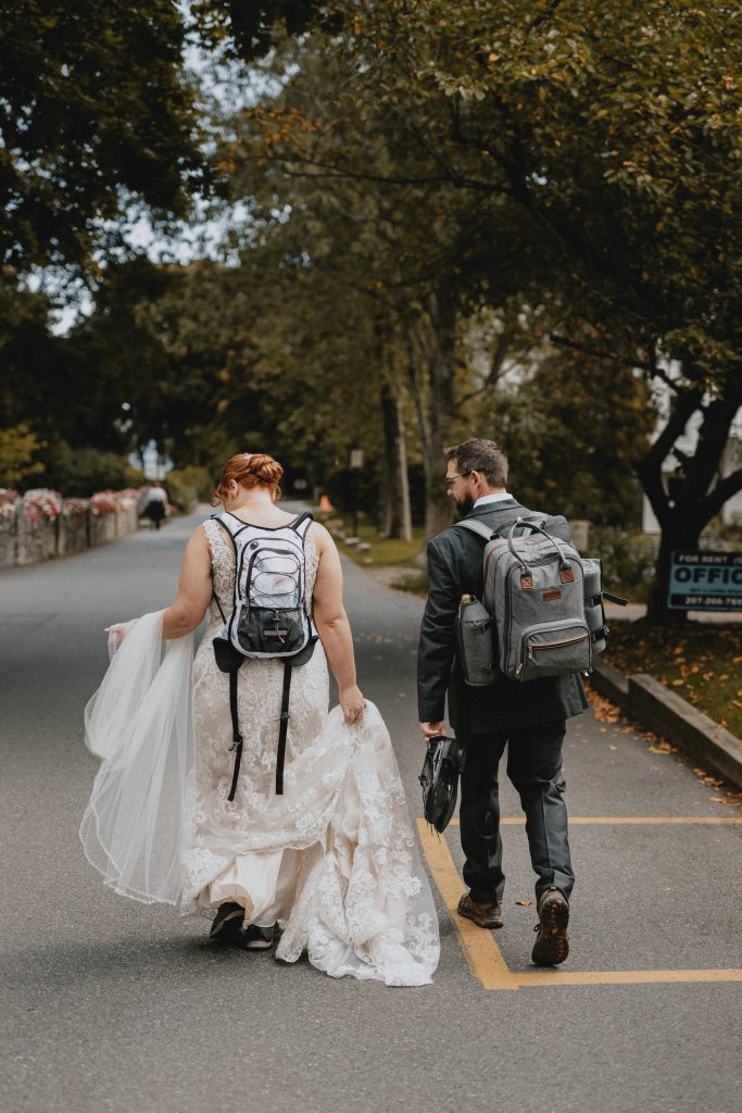 Couple in wedding attire and hiking boots on their wedding day