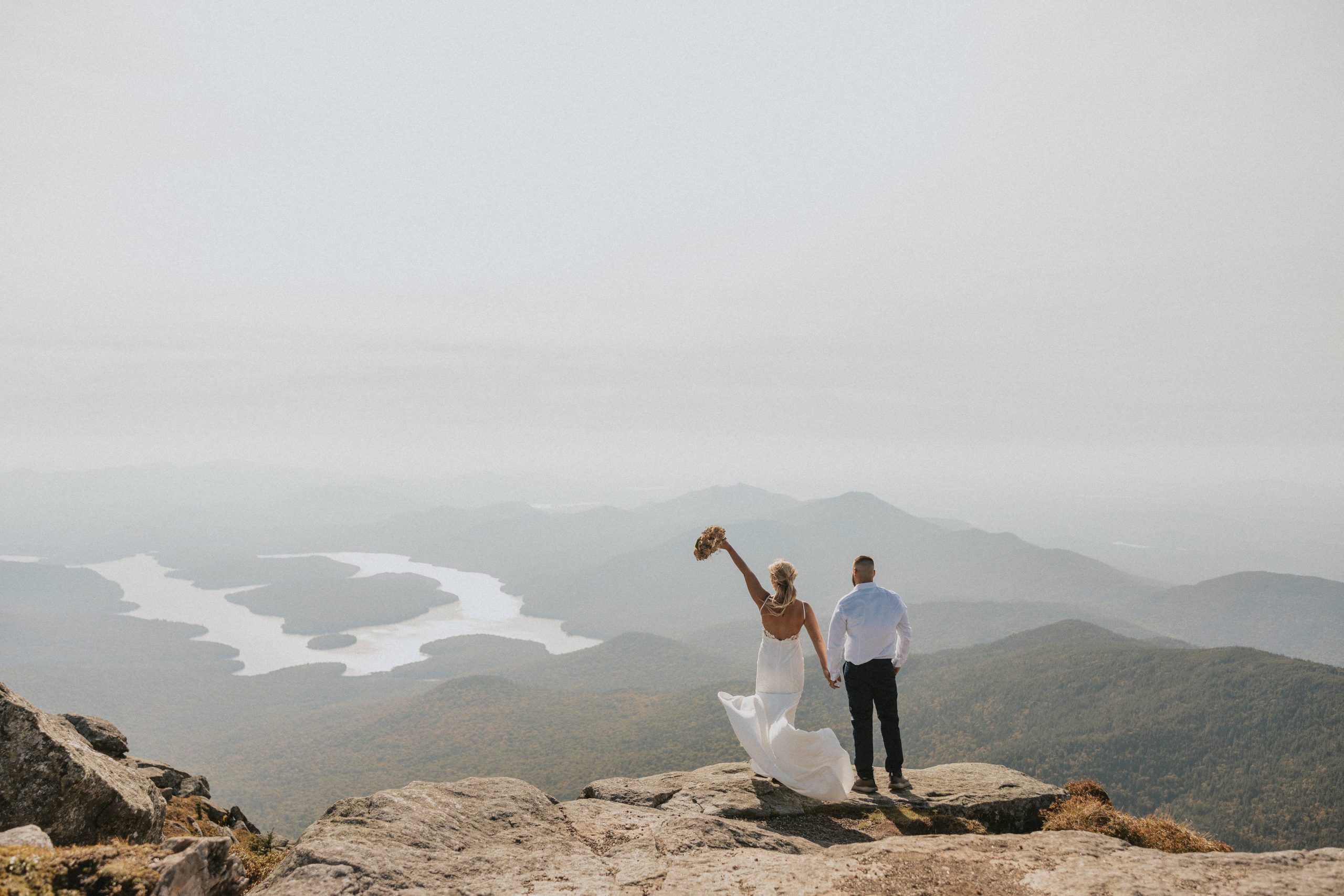 Couple standing on the cliff of Adirondack mountains