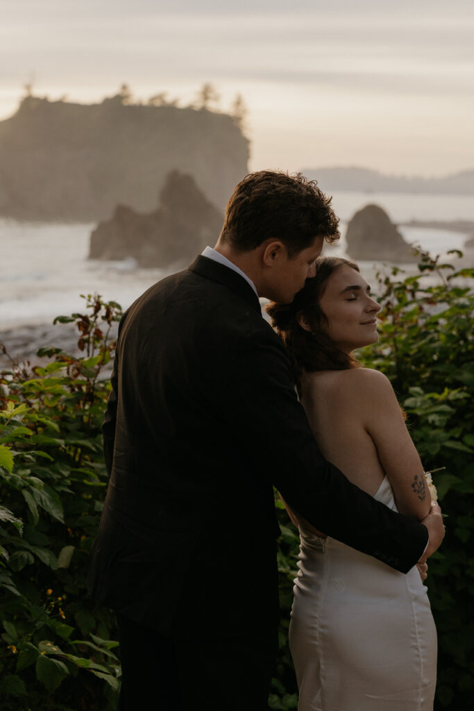 Couple posing in front of Ruby Beach at sunset 